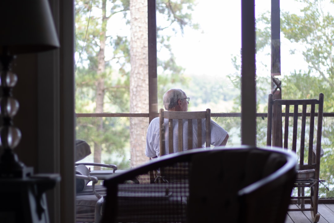 elderly person looking out window, loneliness, senior depression