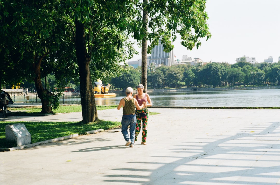 senior couple doing morning walk in park, healthy aging lifestyle