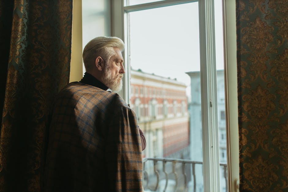 elderly person looking out window, family support, senior depression awareness