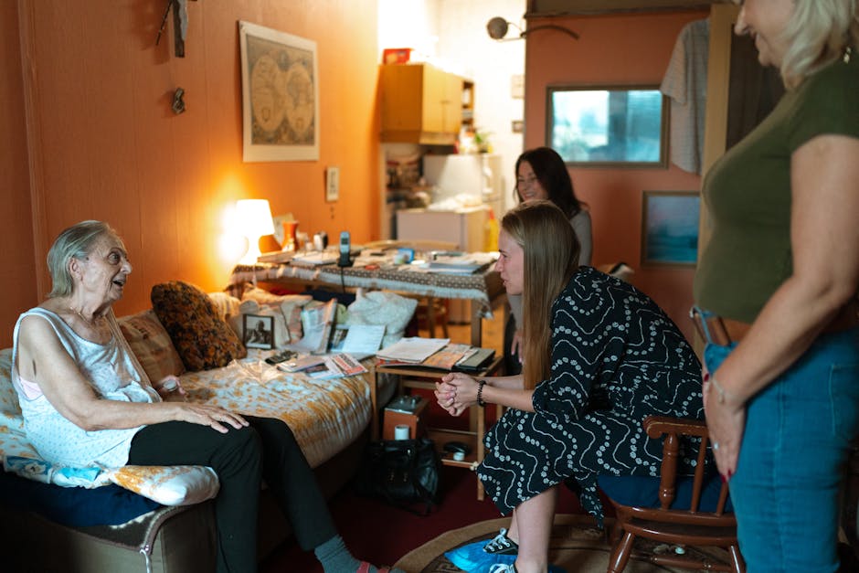 family having gentle conversation with elderly parent, caregiver support at home