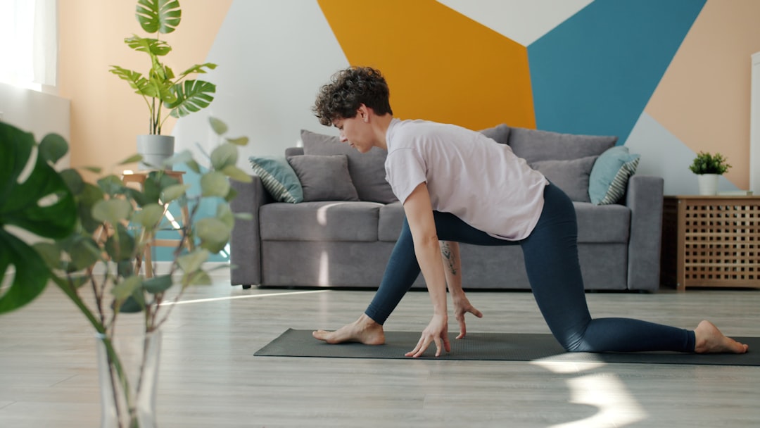 senior woman doing balance exercise at home, fall prevention fitness